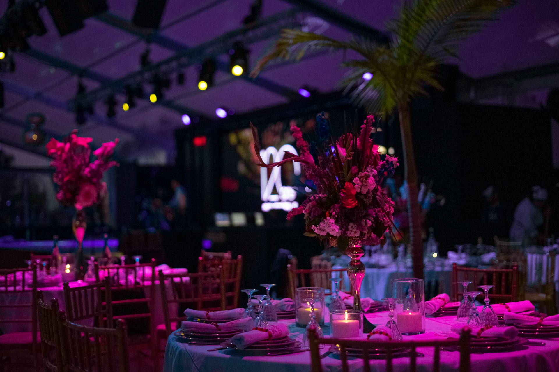 a table set up for a party with candles and flowers